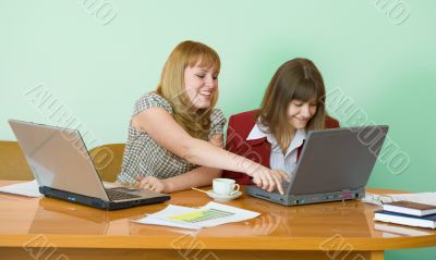 Girls work sitting at a table