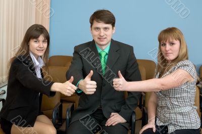 Team of businessmen show thumb up