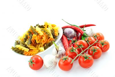 multicolored pasta, pepper, tomato and garlic