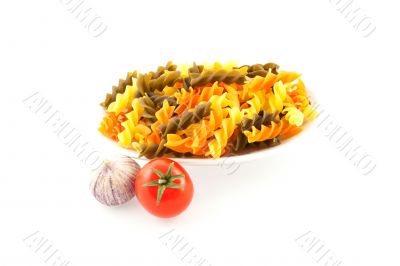 multicolored pasta, one tomato and garlic