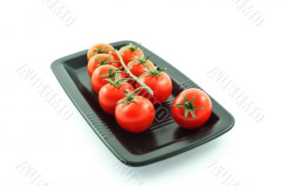 tomatoes bunch on a black plate