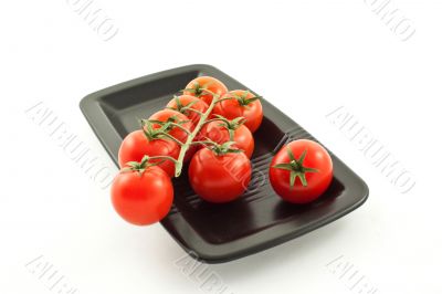 tomatoes bunch on a black plate