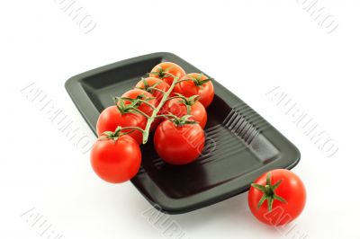 tomatoes bunch on a black plate