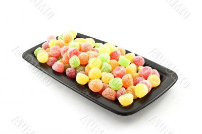 bright color sweets on a black square plate
