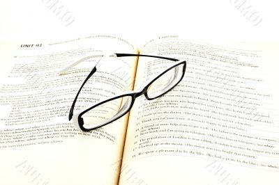 glasses on open book