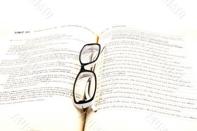 glasses on open book