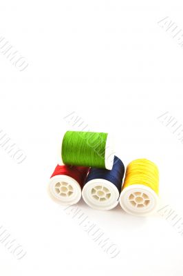 four multicolored spools