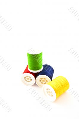 four multicolored spools