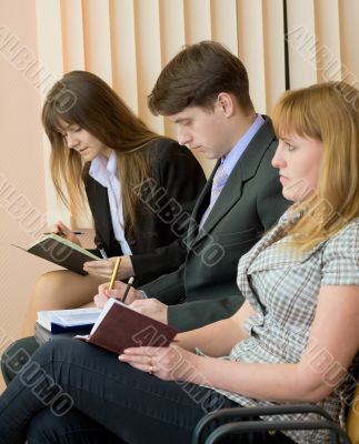 Group of businessmen sitting on armchairs