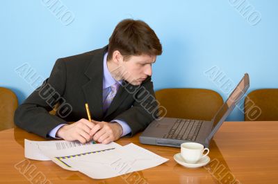 Businessman on a workplace with the laptop