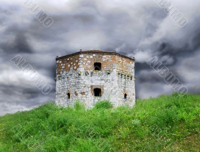 Old stone tower over cloudy sky