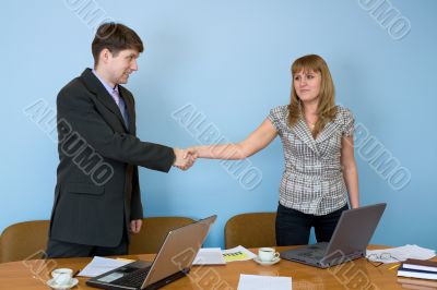 Young businessmen welcome each other