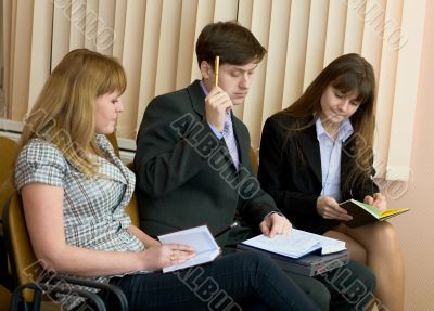 Group of businessmen sitting on armchairs