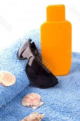 towel, sunglasses and lotion