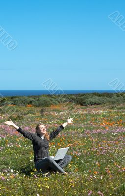 Blonde woman in the field of flowers