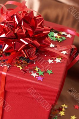 Red gift box with bows and stars