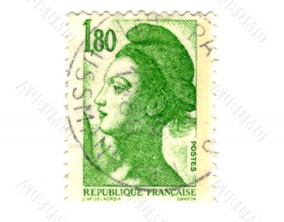 Old green french postage stamp with woman