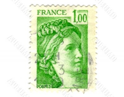 Old green french postage stamp with woman