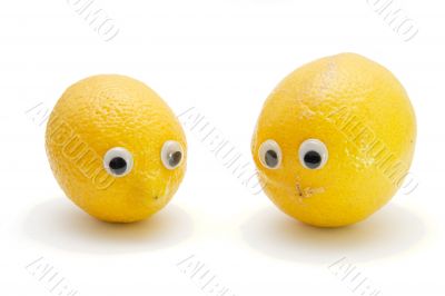Funny lemon fruits with eyes on white