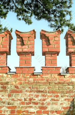 Merlons of red brick wall