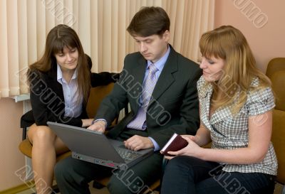 Group of businessmen sitting on armchairs