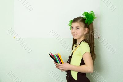 Girl with color pencils and a sheet of paper
