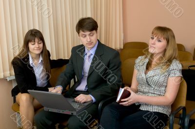 Group of businessmen sitting on armchairs