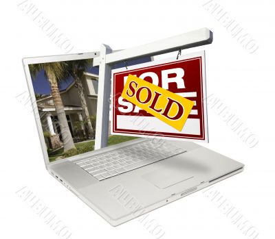 Sold Home for Sale Sign & New Home on Laptop