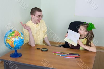 Girl shows new drawing to the brother