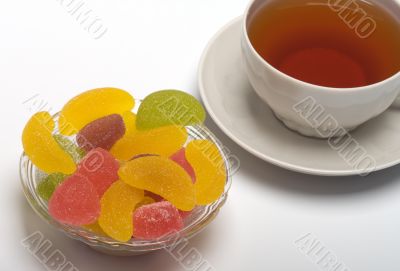 Cup of tea and fruit candy.