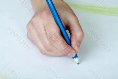 Hand holding a blue pencil