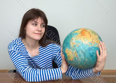 Woman in a stripped vest with globe