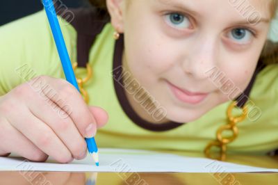 Girl holding a blue pencil