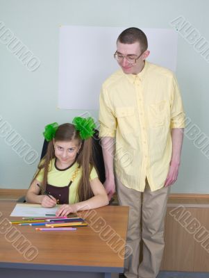 Girl and brother with pencils