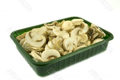 Sliced champignon mushrooms in green pack