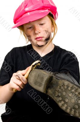 little bootblack girl is shining up the shoes