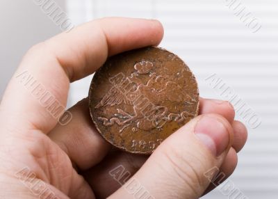 old coin in hand