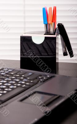 office pens and laptop