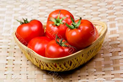 Tomato basket with bamboo mat background