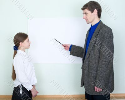 Teacher explains something to the schoolgirl