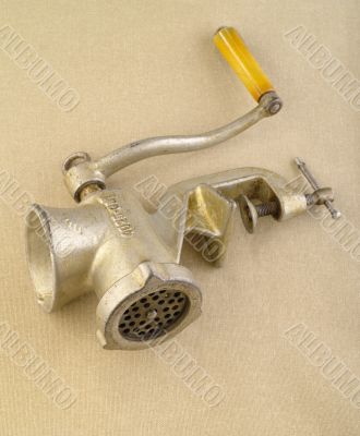Old meat grinder on hessian