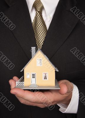 Businessman Holding House