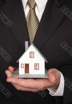 Businessman Holding House