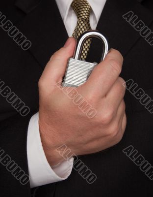 Businessman Holding Large Lock
