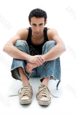 Handsome guy sitting on floor
