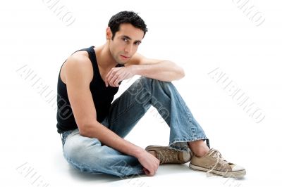 Handsome guy sitting on floor
