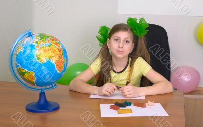 Girl sitting at a table with plasticine