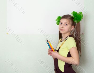 Girl with color pencils and a sheet of paper