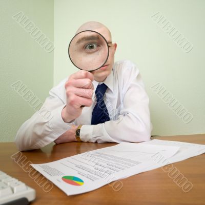 Guy looks through the magnifier