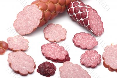 Cutting sausage on white macro
